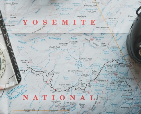 Symbolic image of geodata in media management with compass, map and digital camera